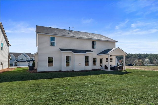 back of house featuring central AC, a yard, and a patio