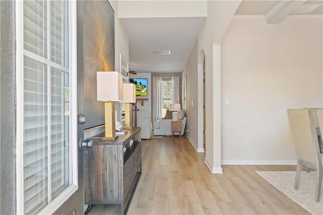 entryway with crown molding, beam ceiling, and light wood-type flooring