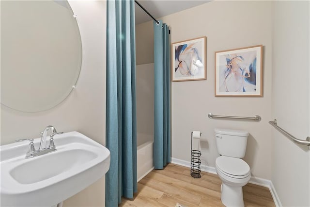 full bathroom featuring toilet, sink, shower / tub combo with curtain, and hardwood / wood-style floors