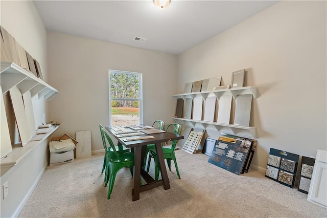 dining area featuring light colored carpet