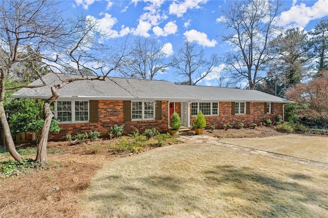 single story home featuring a front lawn and brick siding