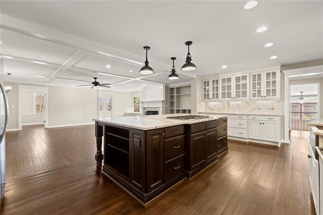 kitchen featuring stainless steel gas cooktop, open floor plan, dark brown cabinetry, white cabinetry, and dark wood-style flooring