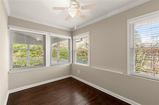 unfurnished room with a ceiling fan, crown molding, baseboards, and dark wood-style flooring