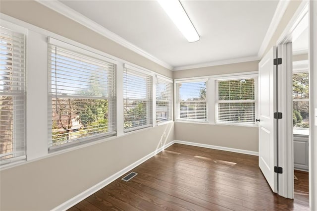 unfurnished sunroom featuring a wealth of natural light and visible vents