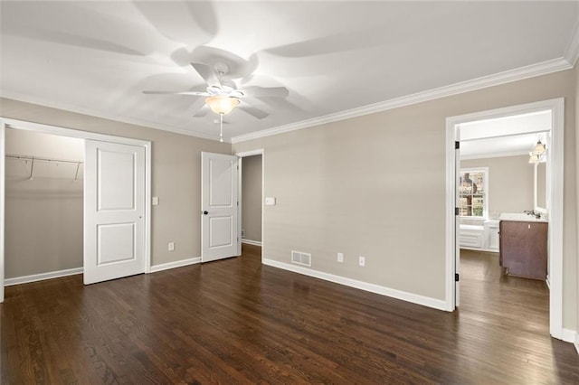 unfurnished bedroom featuring visible vents, a closet, dark wood-style flooring, and crown molding