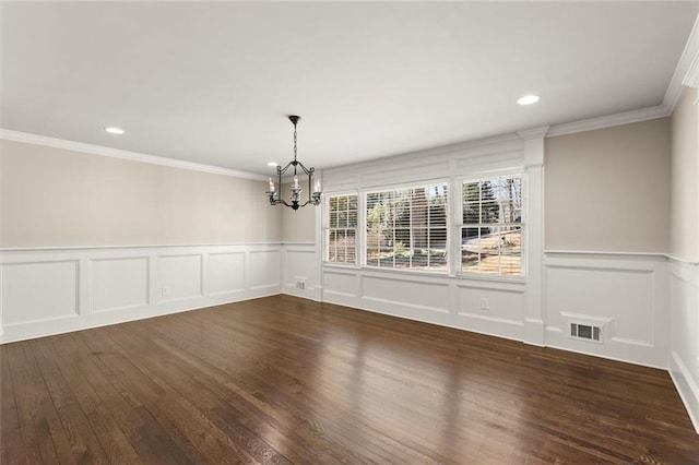 unfurnished dining area featuring dark wood finished floors, visible vents, a notable chandelier, and ornamental molding