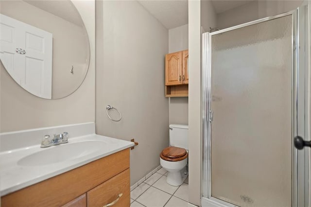 full bathroom with tile patterned flooring, a shower stall, toilet, and vanity