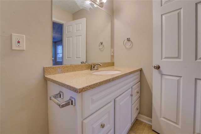 bathroom with tile patterned flooring and vanity