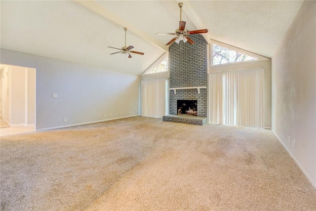 unfurnished living room with carpet flooring, ceiling fan, lofted ceiling with beams, a textured ceiling, and a fireplace