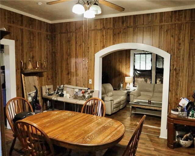 405 Pennington Ave SW, Rome, GA 30161 - dining room featuring wooden walls, crown molding, ceiling fan, arched walkways, and wood finished floors