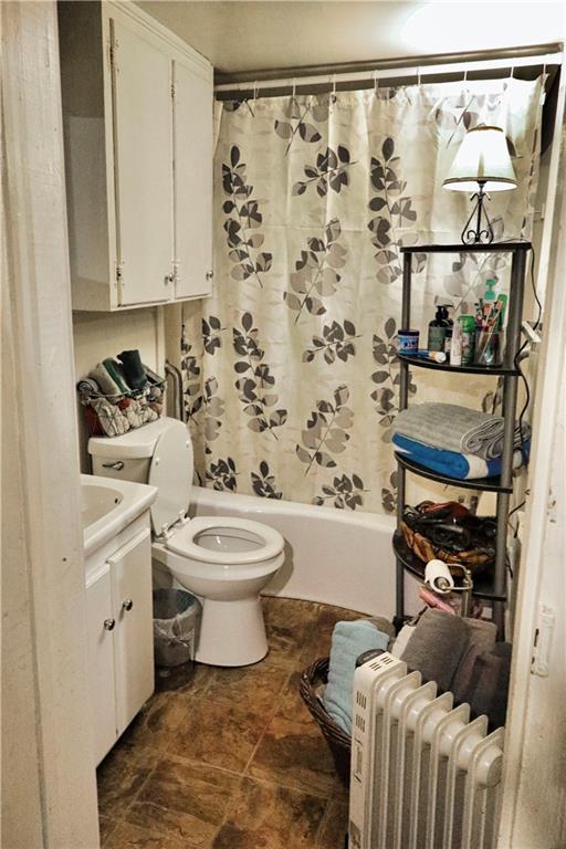 405 Pennington Ave SW, Rome, GA 30161 - full bath with toilet, radiator heating unit, shower / tub combo with curtain, and vanity