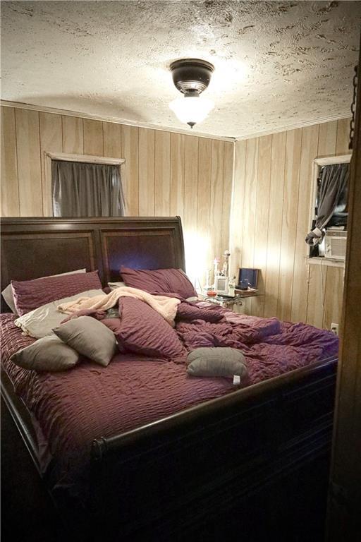 405 Pennington Ave SW, Rome, GA 30161 - bedroom featuring wood walls and a textured ceiling