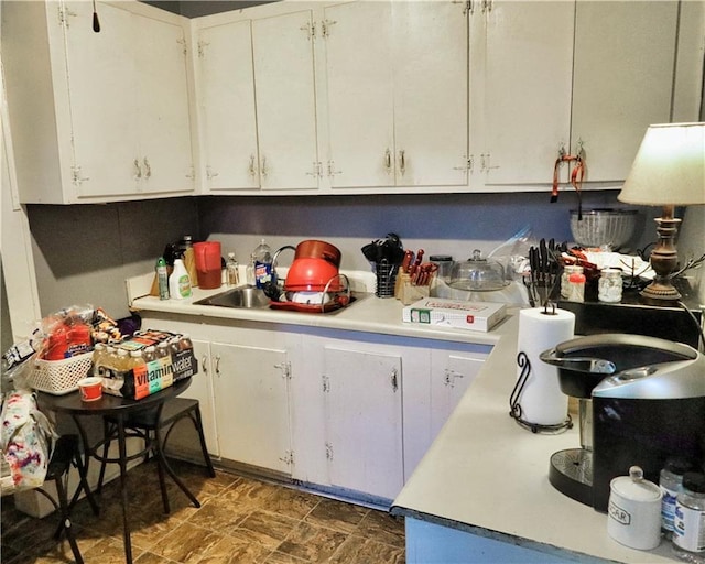 405 Pennington Ave SW, Rome, GA 30161 - kitchen with a sink, light countertops, and white cabinets