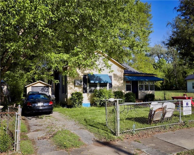 405 Pennington Ave SW, Rome, GA 30161 - view of front of home featuring an outbuilding, stucco siding, a front yard, fence, and driveway