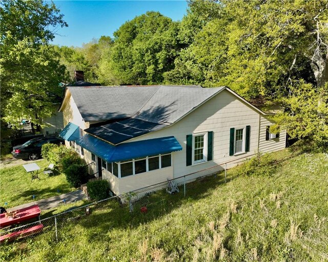405 Pennington Ave SW, Rome, GA 30161 - rear view of property with a yard, roof with shingles, a view of trees, and fence