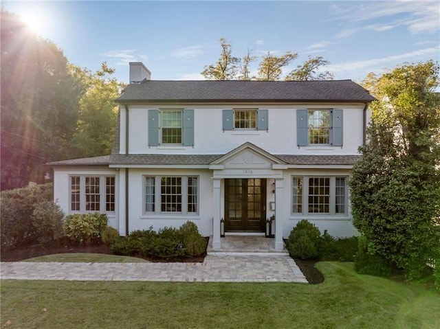 view of front facade with french doors and a front yard