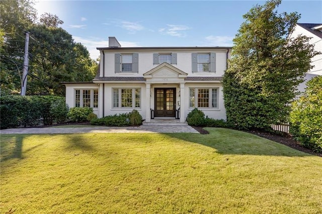 view of front facade with french doors and a front yard