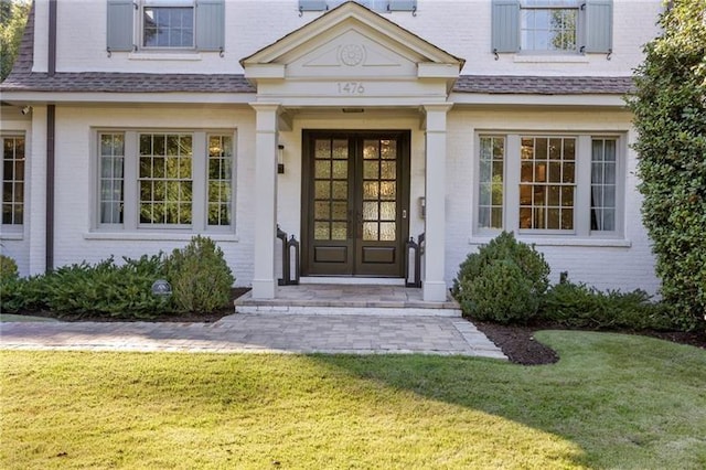 doorway to property featuring french doors and a yard