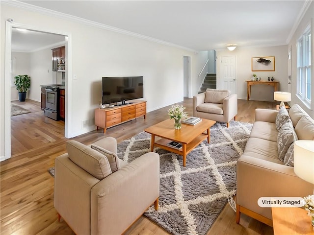 living room featuring light hardwood / wood-style floors and ornamental molding