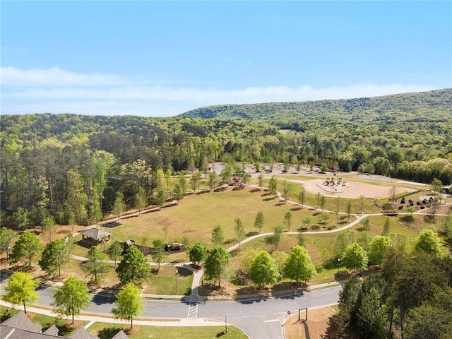 drone / aerial view featuring a wooded view