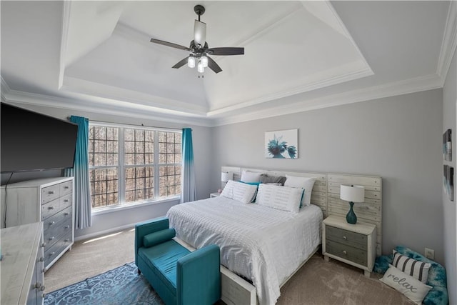 bedroom featuring carpet, a tray ceiling, and ornamental molding