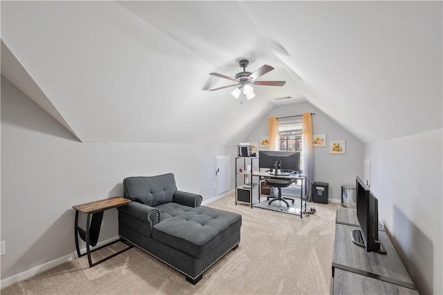 office space with light carpet, ceiling fan, baseboards, and vaulted ceiling