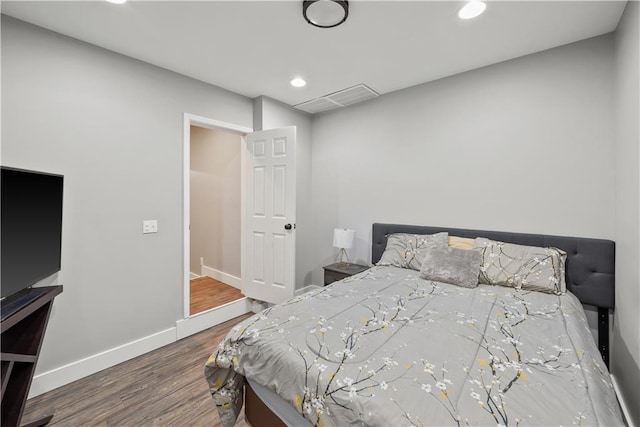 bedroom with visible vents, recessed lighting, baseboards, and wood finished floors