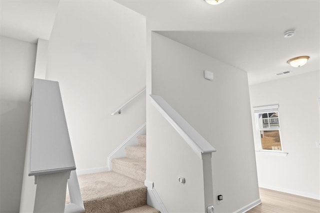 stairs featuring wood-type flooring