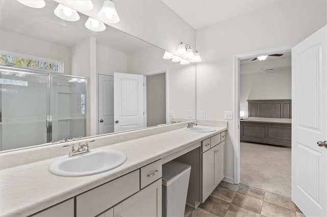 bathroom with vanity, ceiling fan, and walk in shower