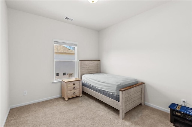 bedroom with light colored carpet