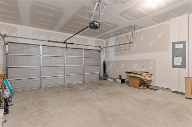 garage with a garage door opener and electric panel