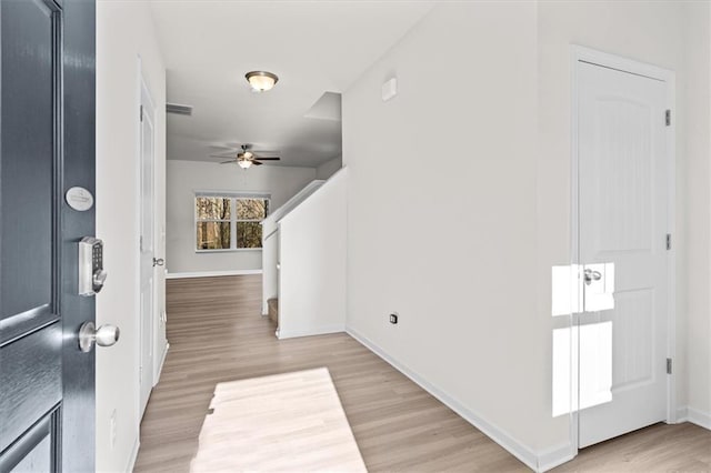 entryway featuring ceiling fan and light hardwood / wood-style floors