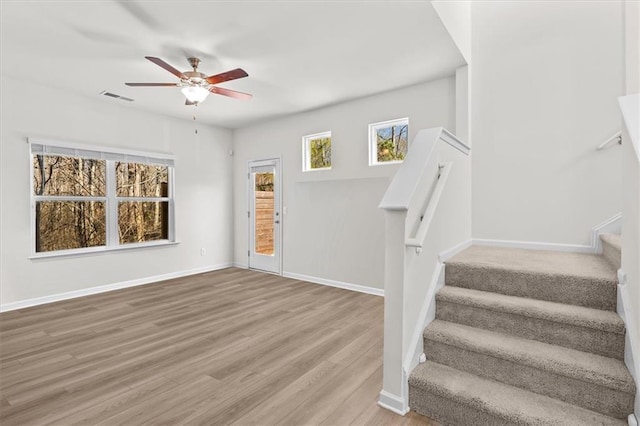 interior space featuring wood-type flooring and ceiling fan