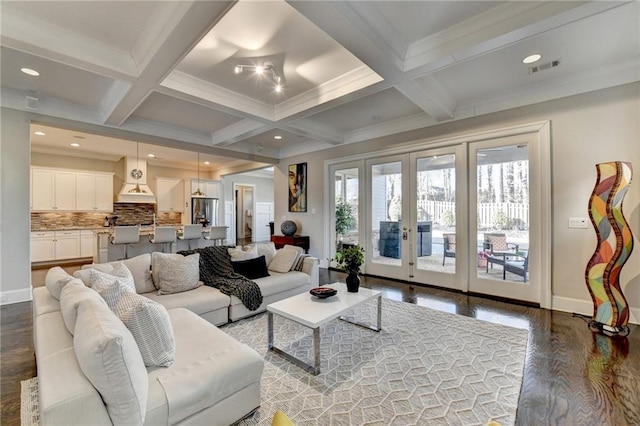 living room featuring french doors, coffered ceiling, ornamental molding, beamed ceiling, and hardwood / wood-style floors