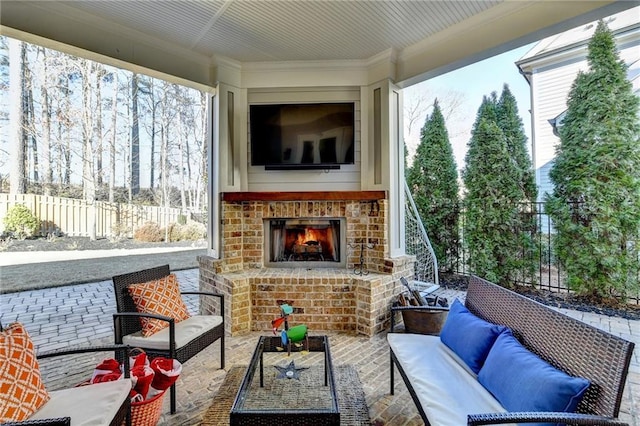 sunroom with an outdoor brick fireplace