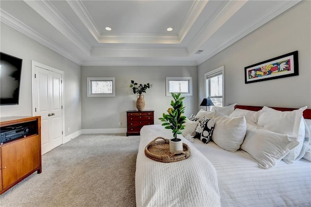 carpeted bedroom featuring a raised ceiling and ornamental molding