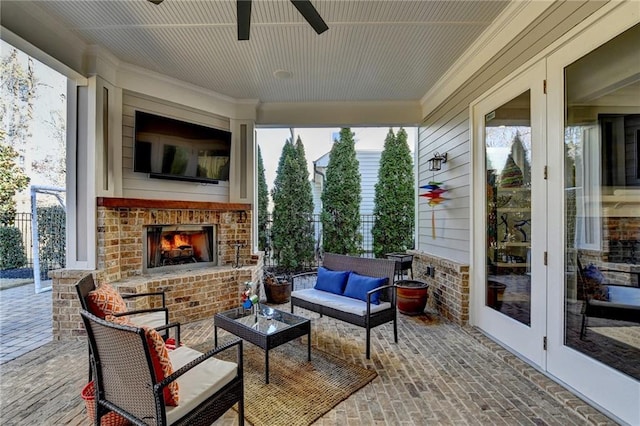 sunroom / solarium with an outdoor brick fireplace and ceiling fan