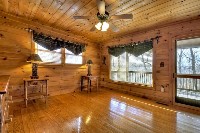 unfurnished room with ceiling fan, wooden ceiling, and light hardwood / wood-style flooring