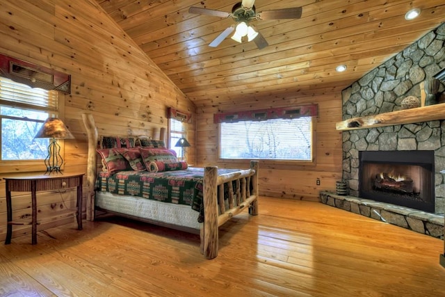 bedroom featuring ceiling fan, wooden walls, wood ceiling, and hardwood / wood-style flooring