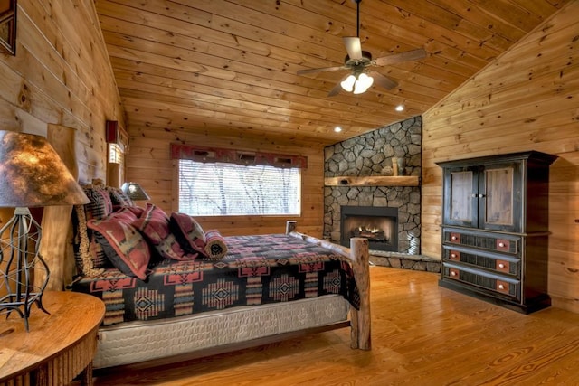 bedroom featuring ceiling fan, wooden ceiling, wood walls, wood-type flooring, and lofted ceiling