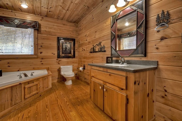 bathroom featuring vanity, wood walls, wooden ceiling, hardwood / wood-style flooring, and toilet