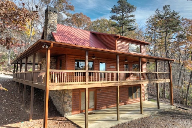 rear view of house featuring ceiling fan, a deck, and a patio