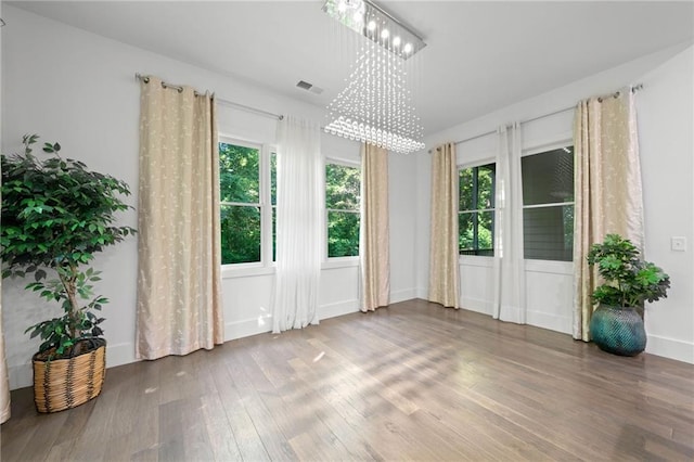 304 Old Cove Rd N, Jasper, GA 30143 - unfurnished room featuring wood finished floors, plenty of natural light, and a chandelier