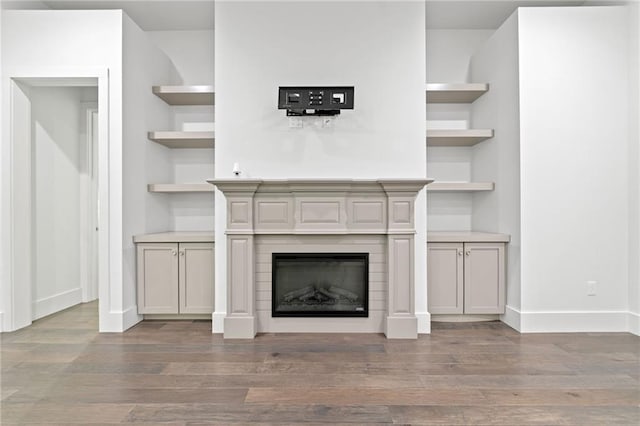 304 Old Cove Rd N, Jasper, GA 30143 - unfurnished living room with wood finished floors, built in features, and a glass covered fireplace