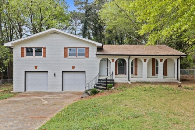 2617 Peggy Sue Ln, Morrow, GA 30260 - split level home with brick siding, an attached garage, concrete driveway, and a porch