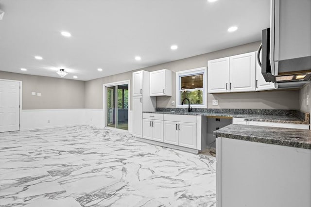 2617 Peggy Sue Ln, Morrow, GA 30260 - kitchen featuring a sink, recessed lighting, light marble finish flooring, white cabinets, and wainscoting