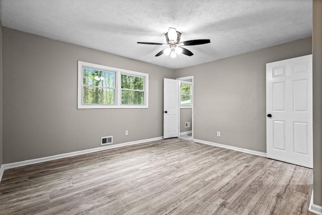 2617 Peggy Sue Ln, Morrow, GA 30260 - unfurnished bedroom with wood finished floors, a textured ceiling, baseboards, and ceiling fan