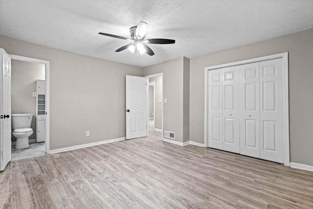2617 Peggy Sue Ln, Morrow, GA 30260 - unfurnished bedroom with light wood finished floors, baseboards, ensuite bath, and a closet