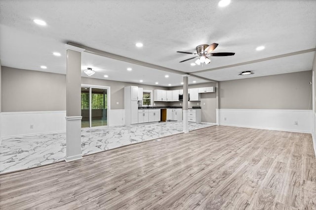 2617 Peggy Sue Ln, Morrow, GA 30260 - unfurnished living room featuring light wood finished floors, wainscoting, recessed lighting, ceiling fan, and a textured ceiling