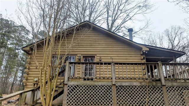 view of home's exterior with a wooden deck